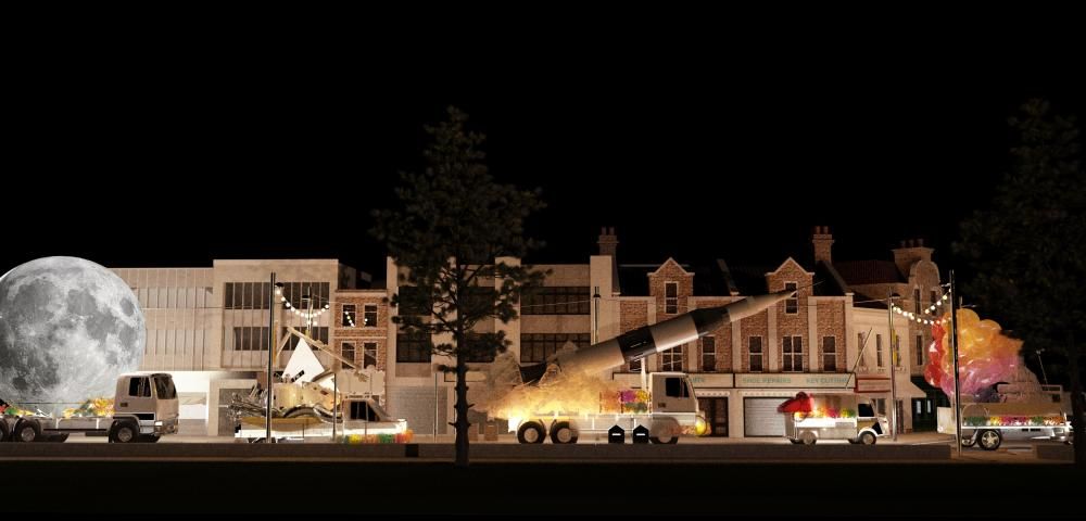 A night-time convoy of vehicles in front of houses and buildings