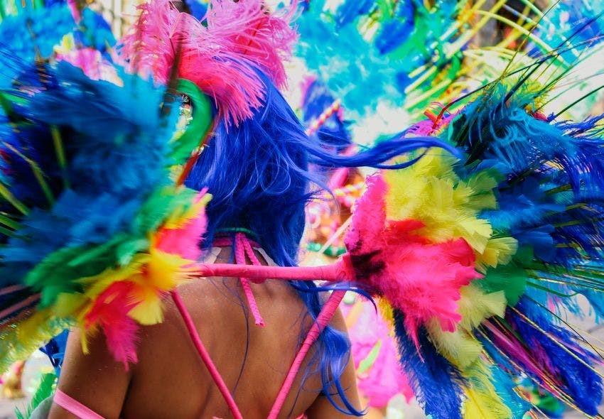 Person wearing a multi-coloured feather outfit